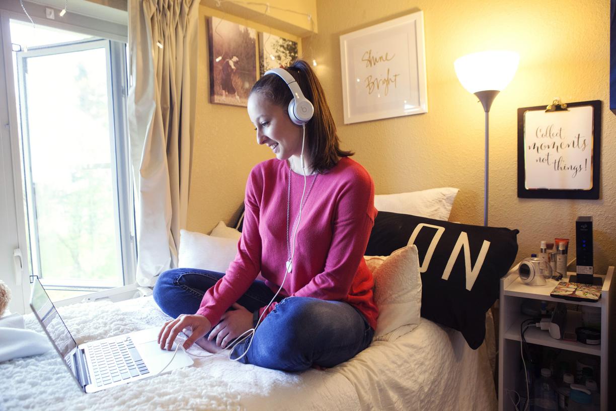 Student doing work online in residence dorm room