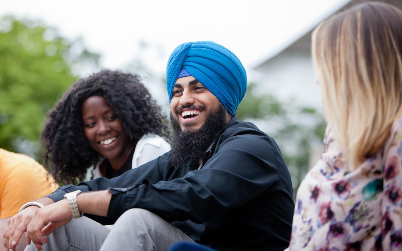 three people talking outside of a building